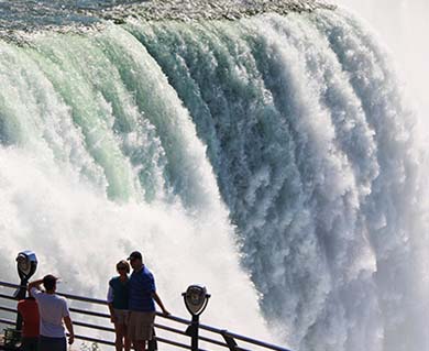 People Standing Next to Niagara Falls